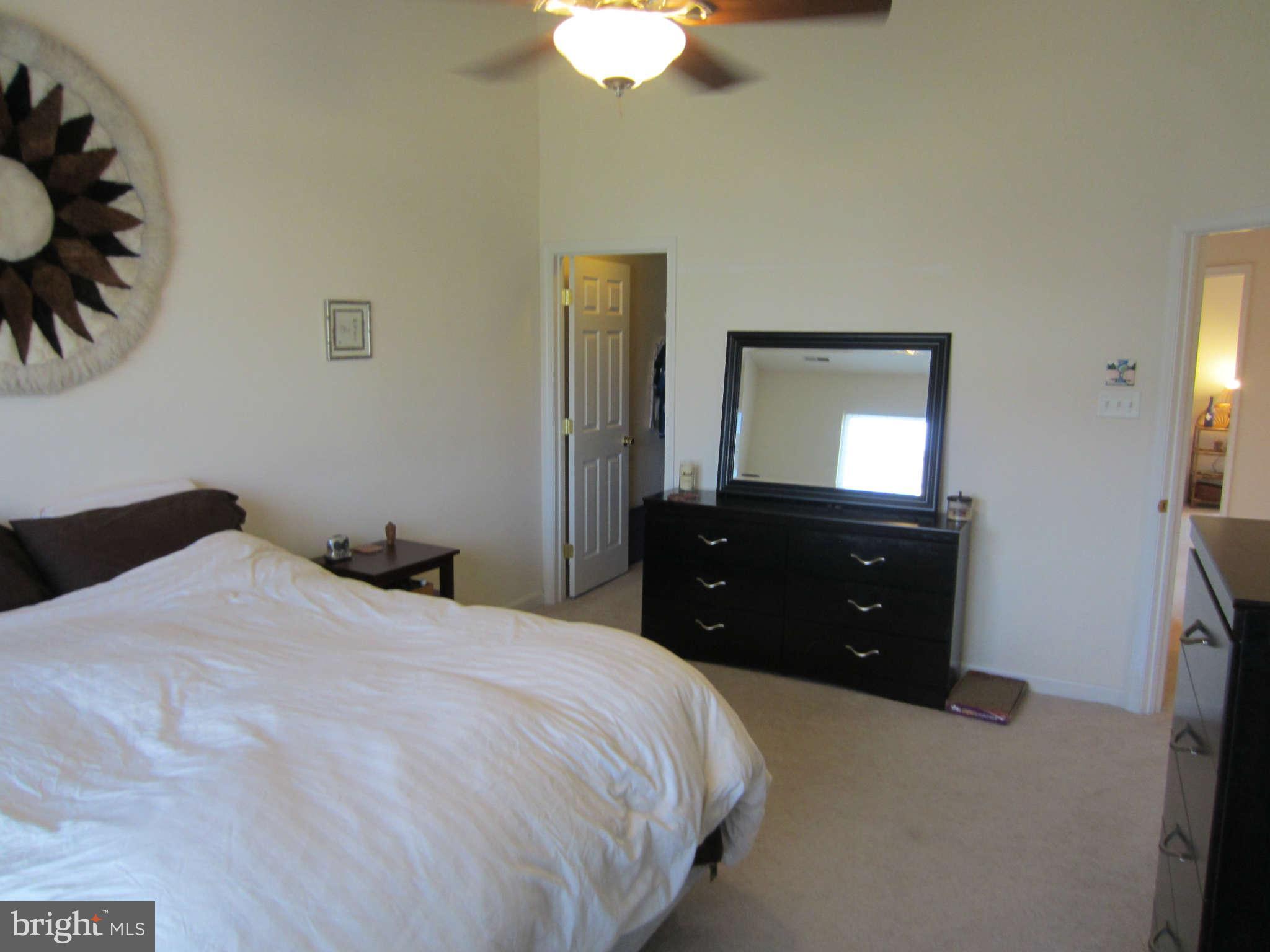 512 Ellison Court Frederick, MD 21703 - Photo 25 of 30 a bedroom with a bed and a chandelier