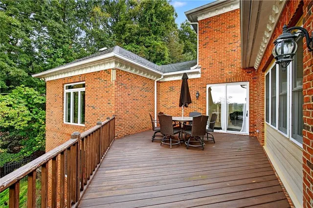 a living room with furniture a fireplace and a large window
