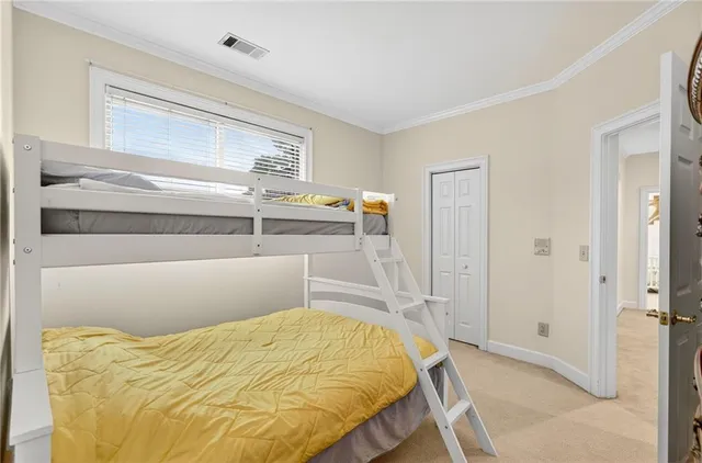 an aerial view of a city with lots of residential buildings ocean and mountain view in back