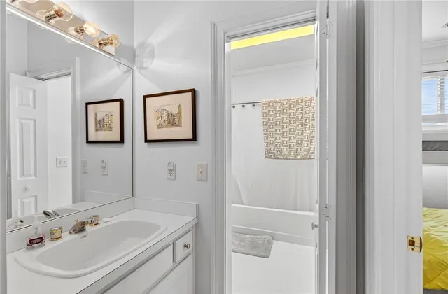 an aerial view of a houses with a yard and lake view