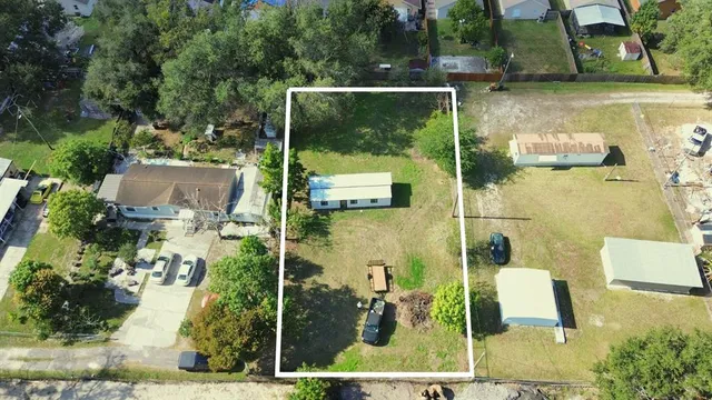 aerial view of a house with a yard