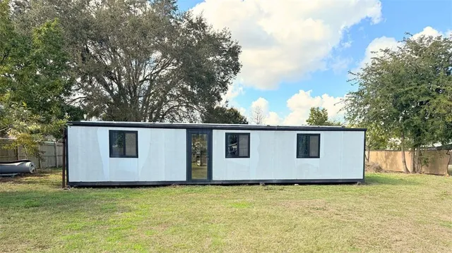 a backyard of house with garage