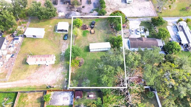 an aerial view of residential houses with outdoor space and street view