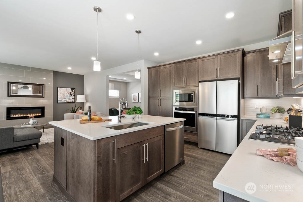 22917 20th Place West Bothell, WA 98021 - Photo 15 of 32 a kitchen with a sink a stove a refrigerator and a refrigerator