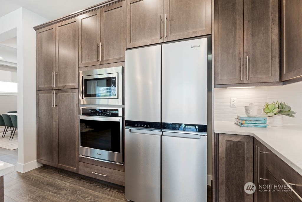 22917 20th Place West Bothell, WA 98021 - Photo 16 of 32 a kitchen with metallic refrigerator and cabinets