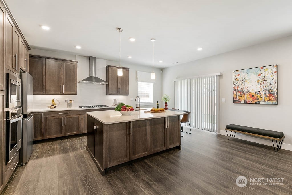 22917 20th Place West Bothell, WA 98021 - Photo 19 of 32 a large kitchen with a large counter top a sink stainless steel appliances and cabinets