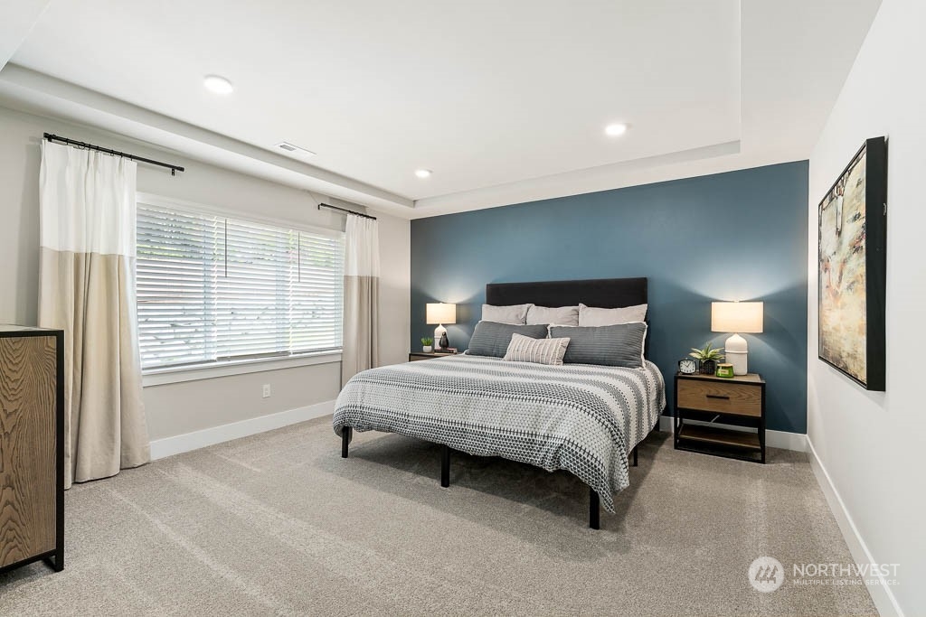 22917 20th Place West Bothell, WA 98021 - Photo 21 of 32 a spacious bedroom with a bed and a large window