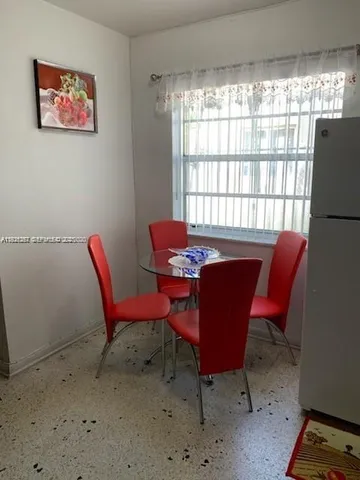 a dining room with furniture and window