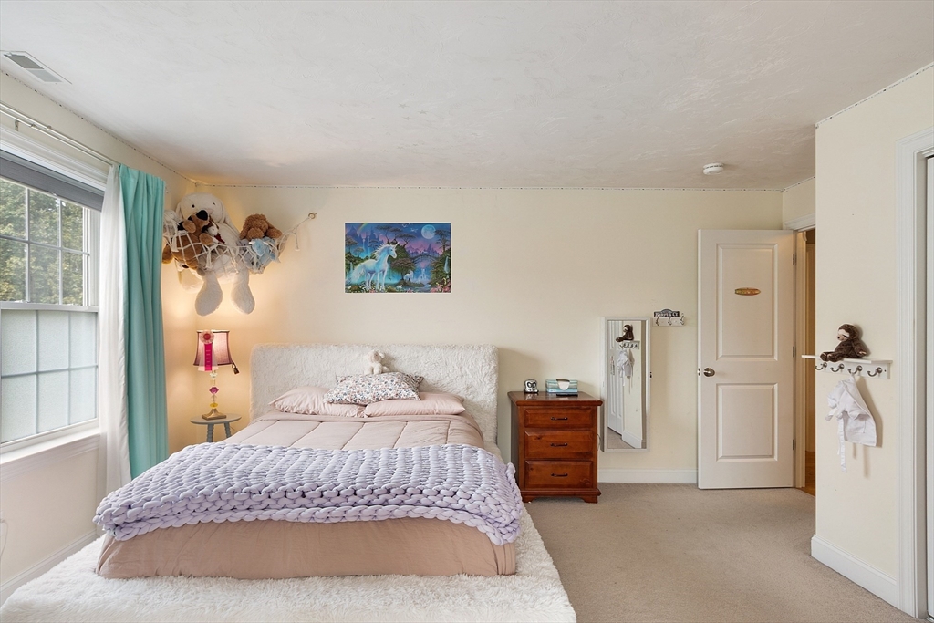 46 Jordan Road Holden, MA 01520 - Photo 24 of 42 a bedroom with a bed and a painting on the wall