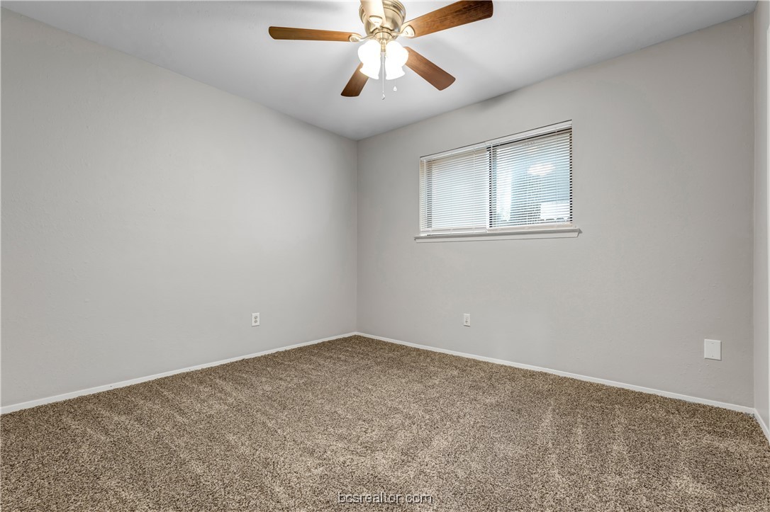 802-804 Navidad Street Bryan, TX 77801 - Photo 20 of 48 an empty room with a chandelier fan and windows