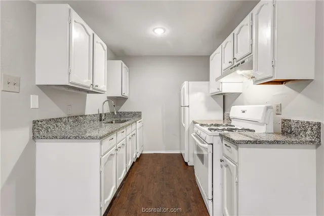 a kitchen with stainless steel appliances granite countertop a sink stove and cabinets