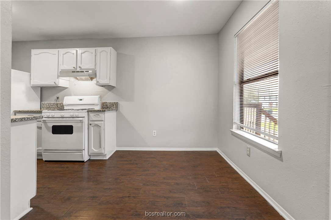 802-804 Navidad Street Bryan, TX 77801 - Photo 25 of 48 a kitchen with a stove a sink and white cabinets