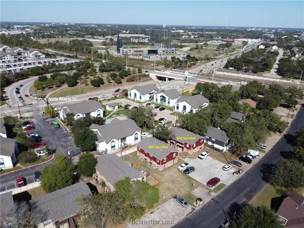 an aerial view of residential houses with outdoor space