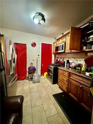 a kitchen with stainless steel appliances kitchen island granite countertop a sink and cabinets