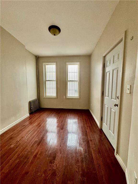 527 49th Street Brooklyn, NY 11220 - Photo 5 of 9 an empty room with wooden floor and windows