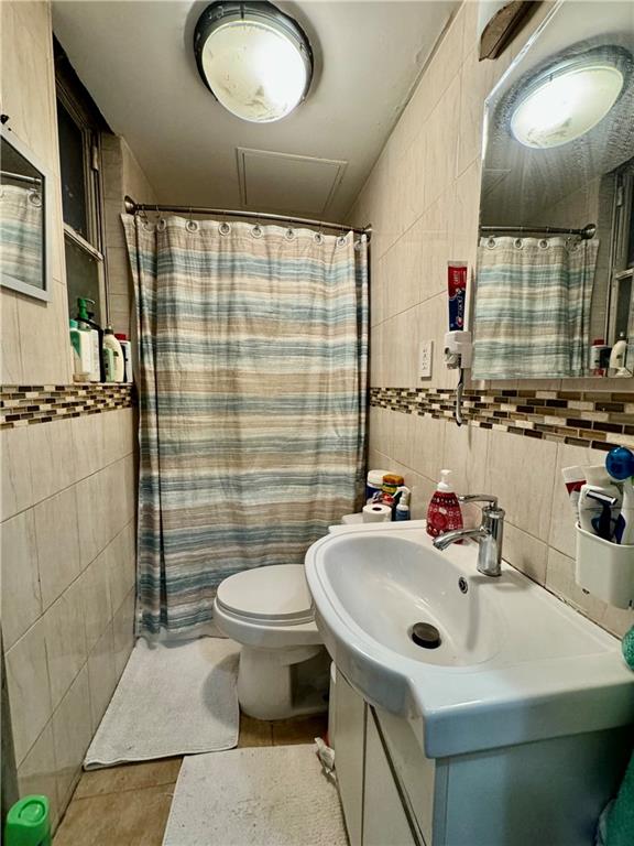 527 49th Street Brooklyn, NY 11220 - Photo 6 of 9 a bathroom with a sink toilet and shower