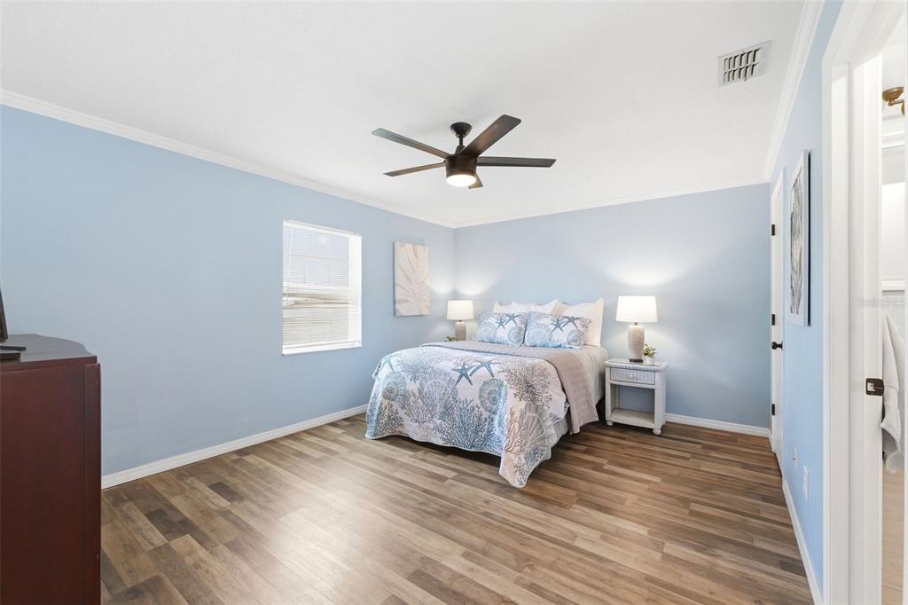 6129 Elmhurst Drive New Port Richey, FL 34653 - Photo 11 of 34 a bedroom with a bed and a ceiling fan