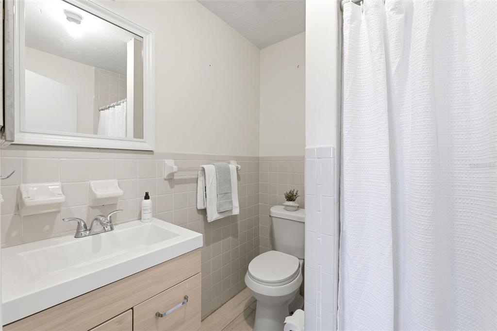 6129 Elmhurst Drive New Port Richey, FL 34653 - Photo 13 of 34 a bathroom with a sink a toilet and a mirror