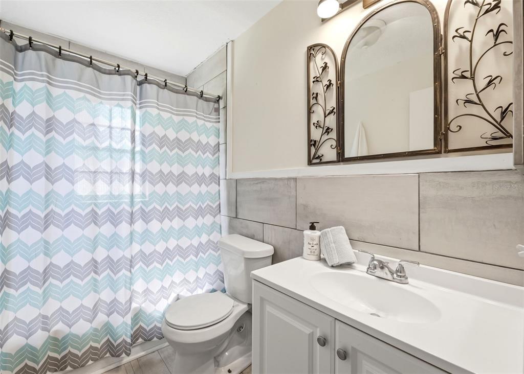 6129 Elmhurst Drive New Port Richey, FL 34653 - Photo 14 of 34 a bathroom with a sink toilet and shower