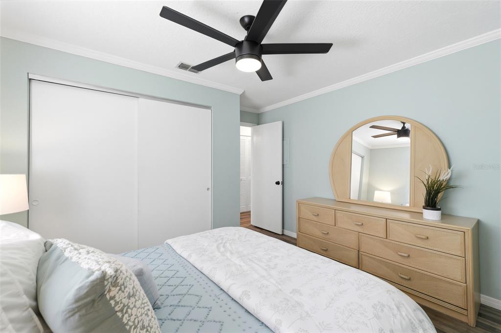 6129 Elmhurst Drive New Port Richey, FL 34653 - Photo 16 of 34 a bedroom with a bed and a mirror on dresser