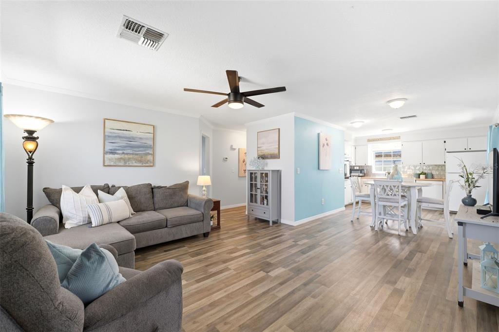 6129 Elmhurst Drive New Port Richey, FL 34653 - Photo 2 of 34 a living room with furniture and a wooden floor
