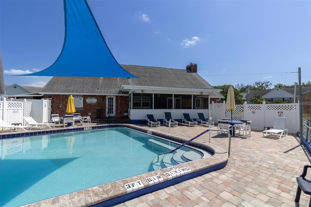 6129 Elmhurst Drive New Port Richey, FL 34653 - Photo 30 of 34 a view of a house with swimming pool and sitting area