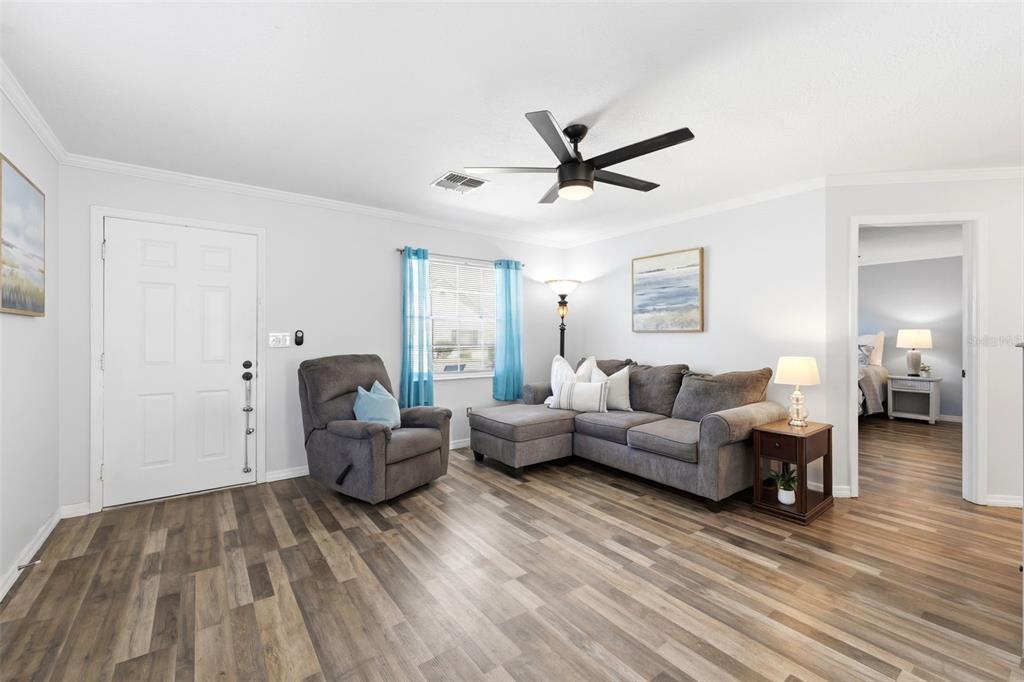 6129 Elmhurst Drive New Port Richey, FL 34653 - Photo 4 of 34 a living room with furniture and a wooden floor