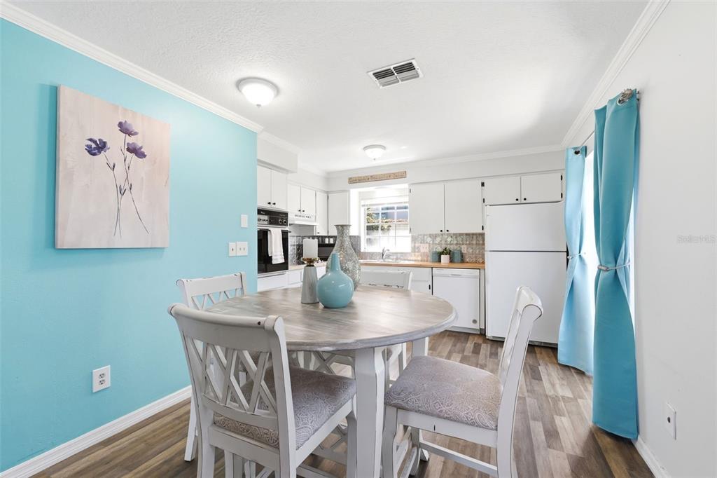 6129 Elmhurst Drive New Port Richey, FL 34653 - Photo 6 of 34 a kitchen with stainless steel appliances granite countertop a dining table and chairs