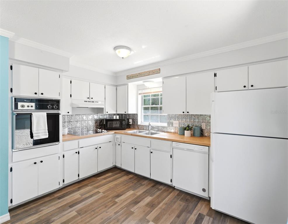 6129 Elmhurst Drive New Port Richey, FL 34653 - Photo 7 of 34 a kitchen with appliances a sink and cabinets