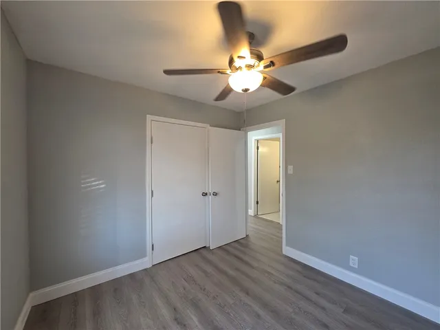 a view of a small space with wooden floor and a window