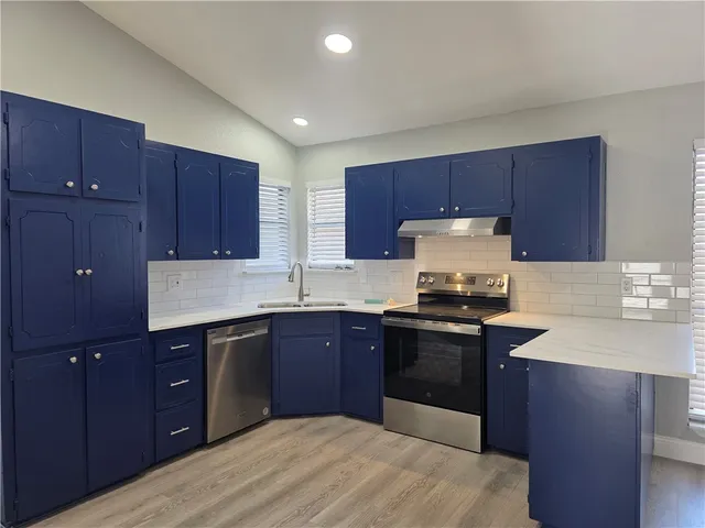 a kitchen with wooden cabinets and sink