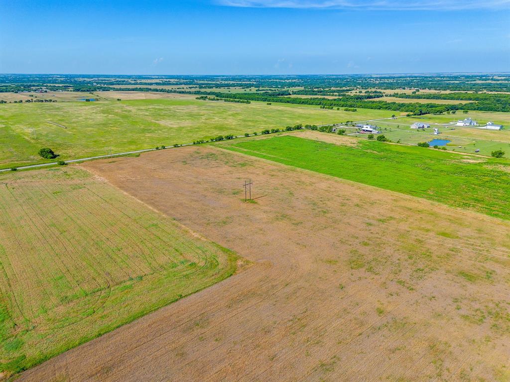 6785 Hoehn Road Valley View, TX 76272 - Photo 11 of 14 Expansive land parcel featuring open fields, distant treelines, and clear skies