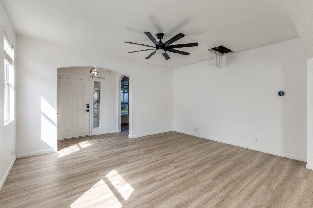 9204 Magna Carta Loop Austin, TX 78754 - Photo 3 of 27 a view of empty room with wooden floor and fan