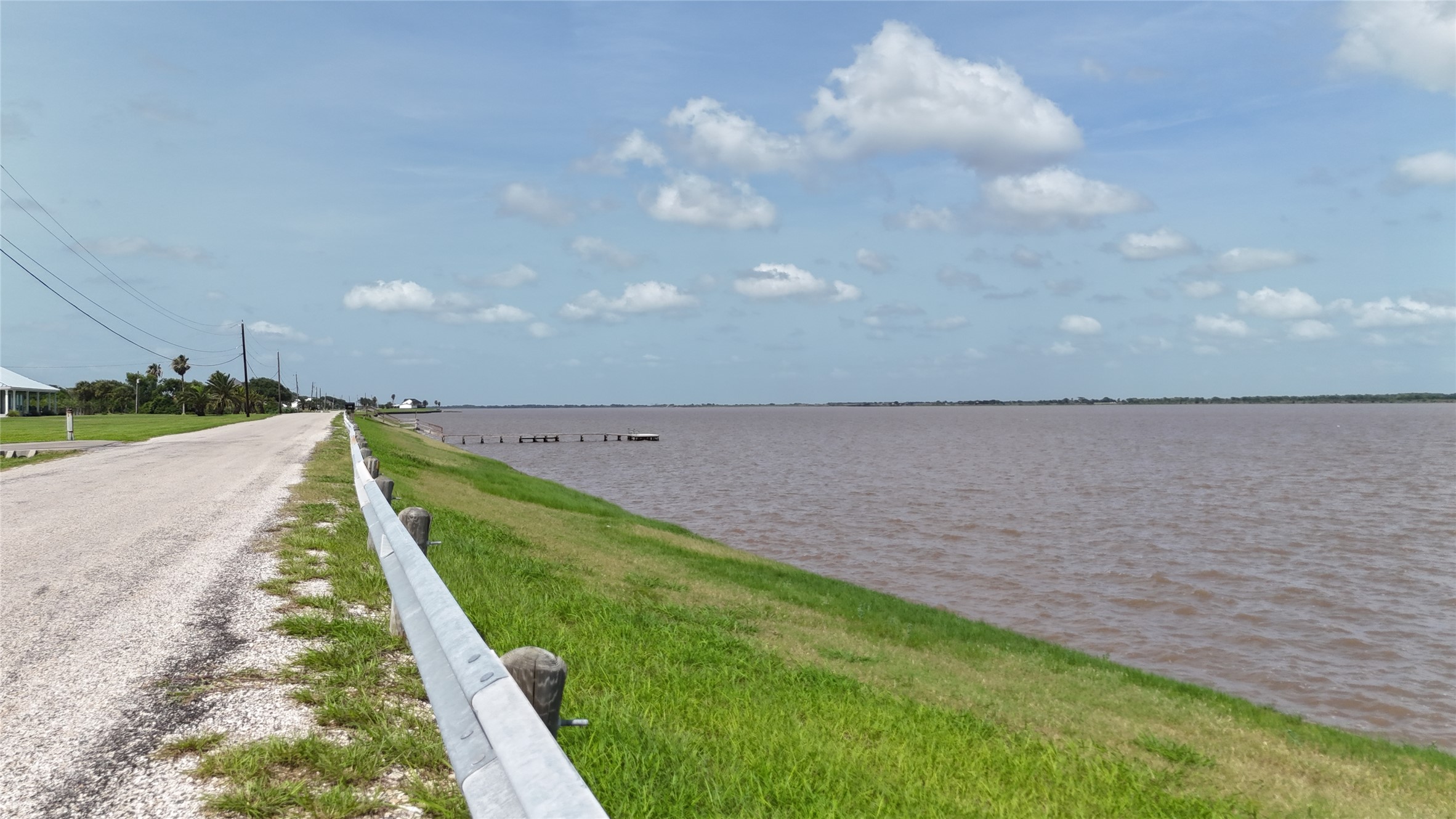 305 Bayshore Road Palacios, TX 77465 - Photo 5 of 25 A tranquil lakeside road offers direct access to the water's edge, ideal for peaceful retreats.