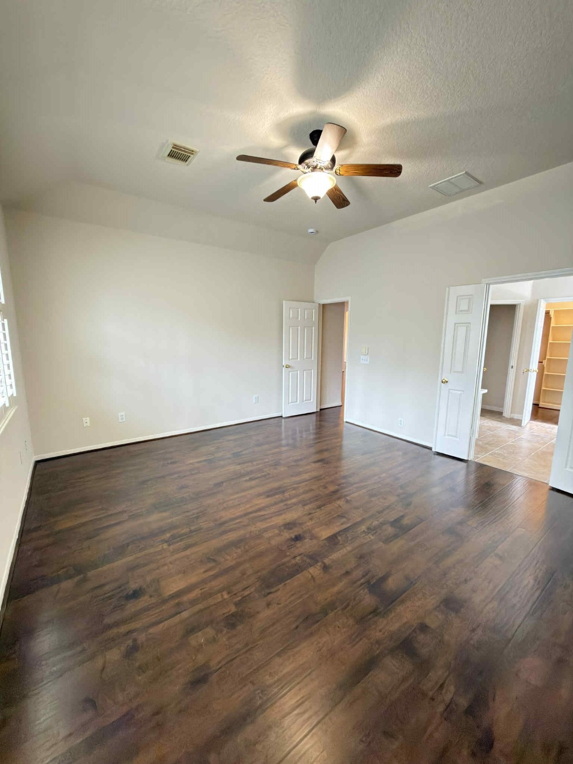 9531 Summer Run Houston, TX 77064 - Photo 13 of 29 a view of an empty room with wooden floor and a ceiling fan