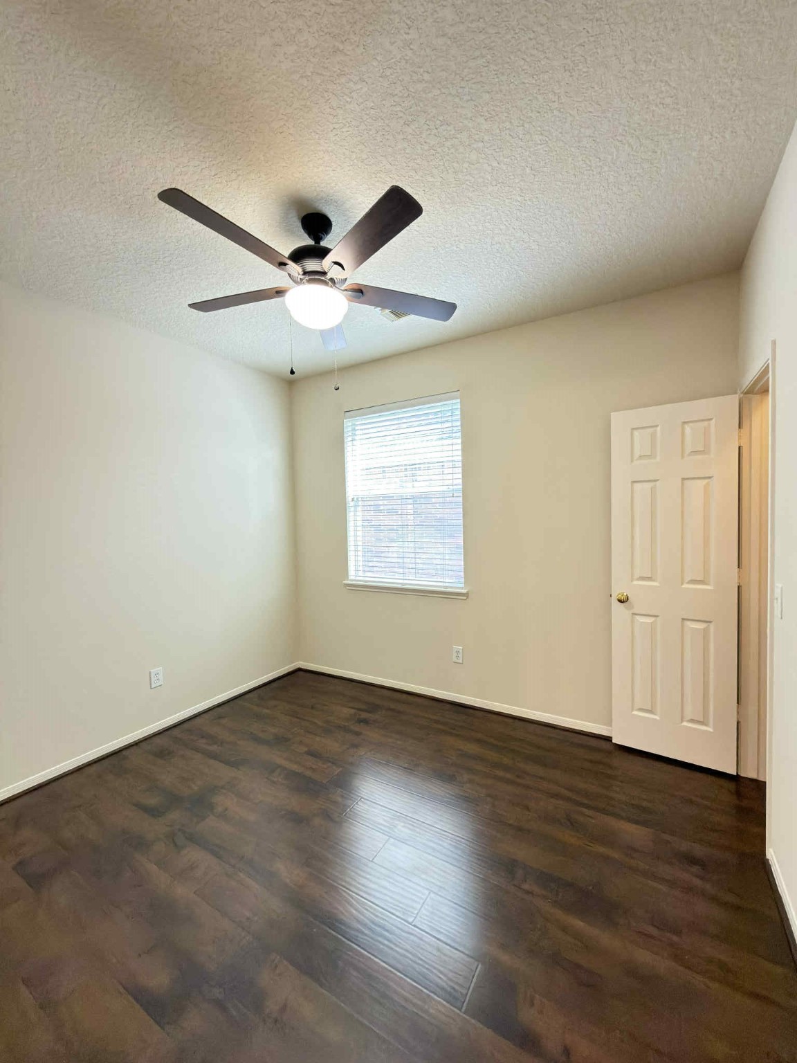 9531 Summer Run Houston, TX 77064 - Photo 21 of 29 an empty room with wooden floor ceiling fan and windows
