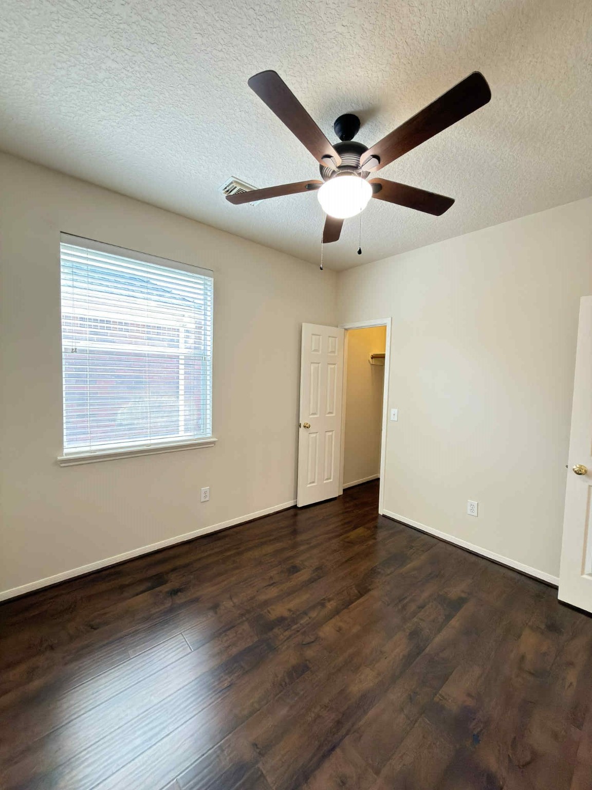 9531 Summer Run Houston, TX 77064 - Photo 22 of 29 a view of an empty room with wooden floor and a ceiling fan