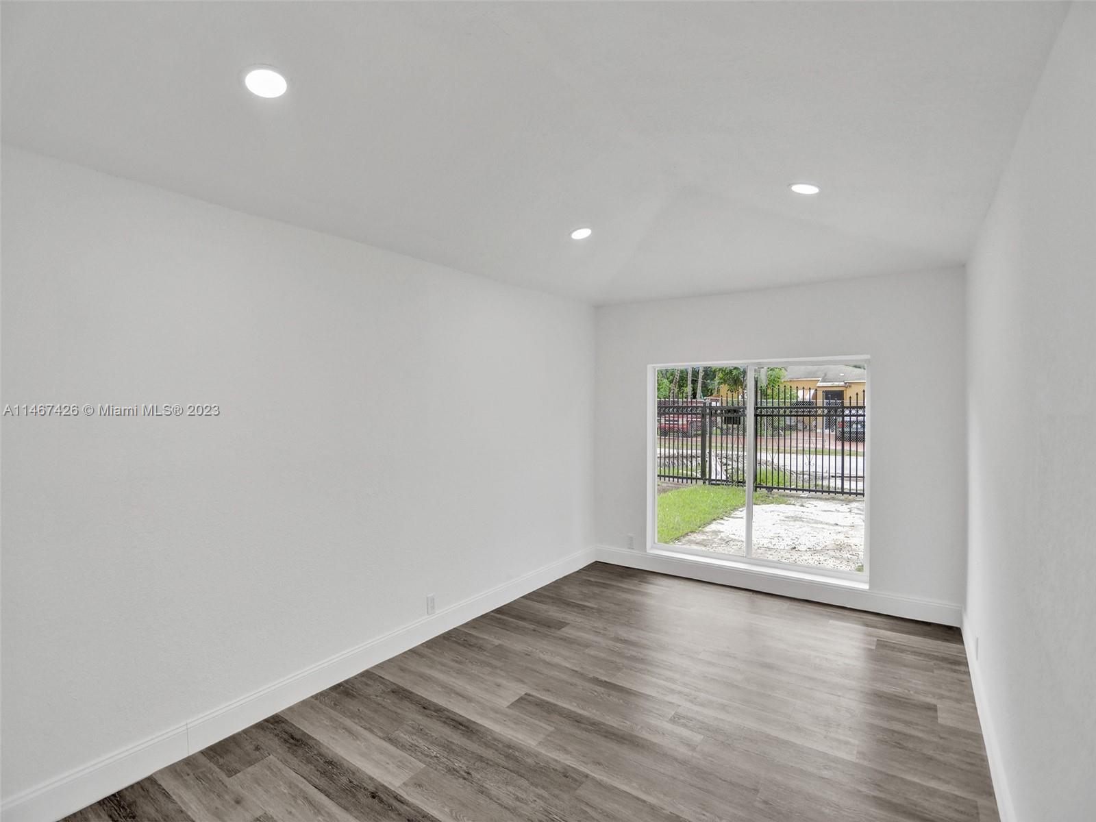 167 Northwest 84th Street Miami, FL 33150 - Photo 15 of 39 an empty room with wooden floor and window