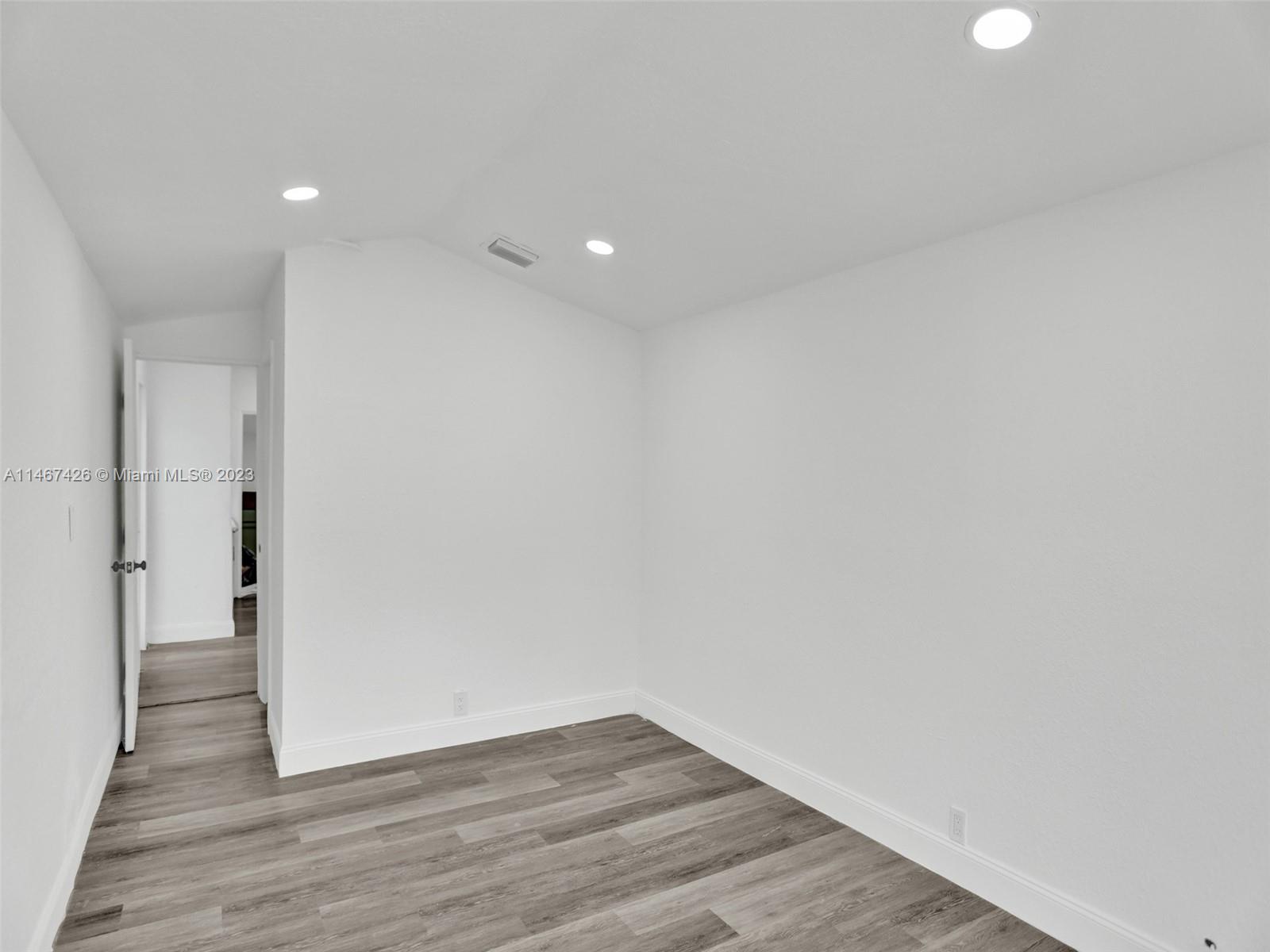 167 Northwest 84th Street Miami, FL 33150 - Photo 16 of 39 a view of an empty room with wooden floor
