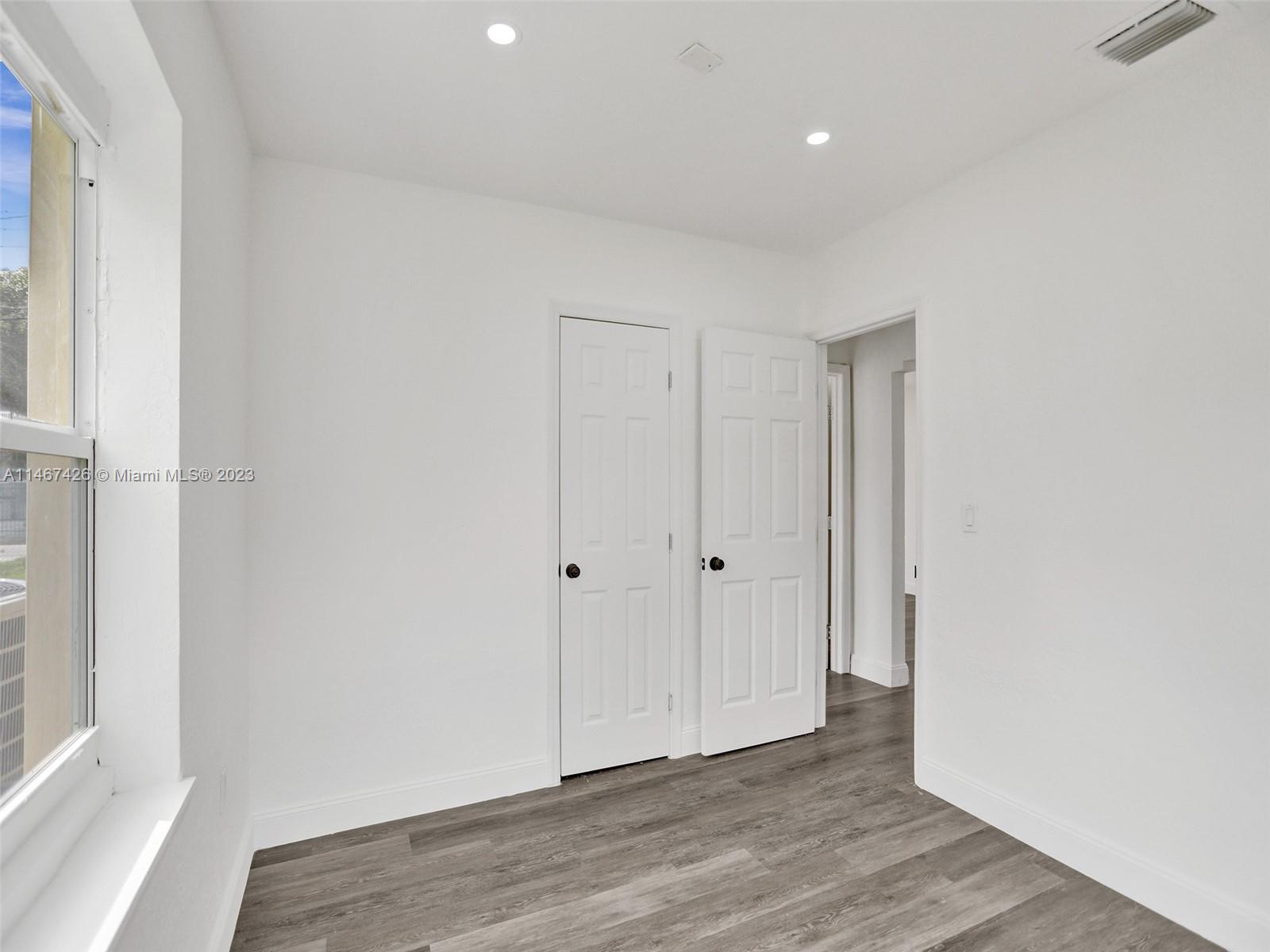 167 Northwest 84th Street Miami, FL 33150 - Photo 22 of 39 a view of an empty room with wooden floor