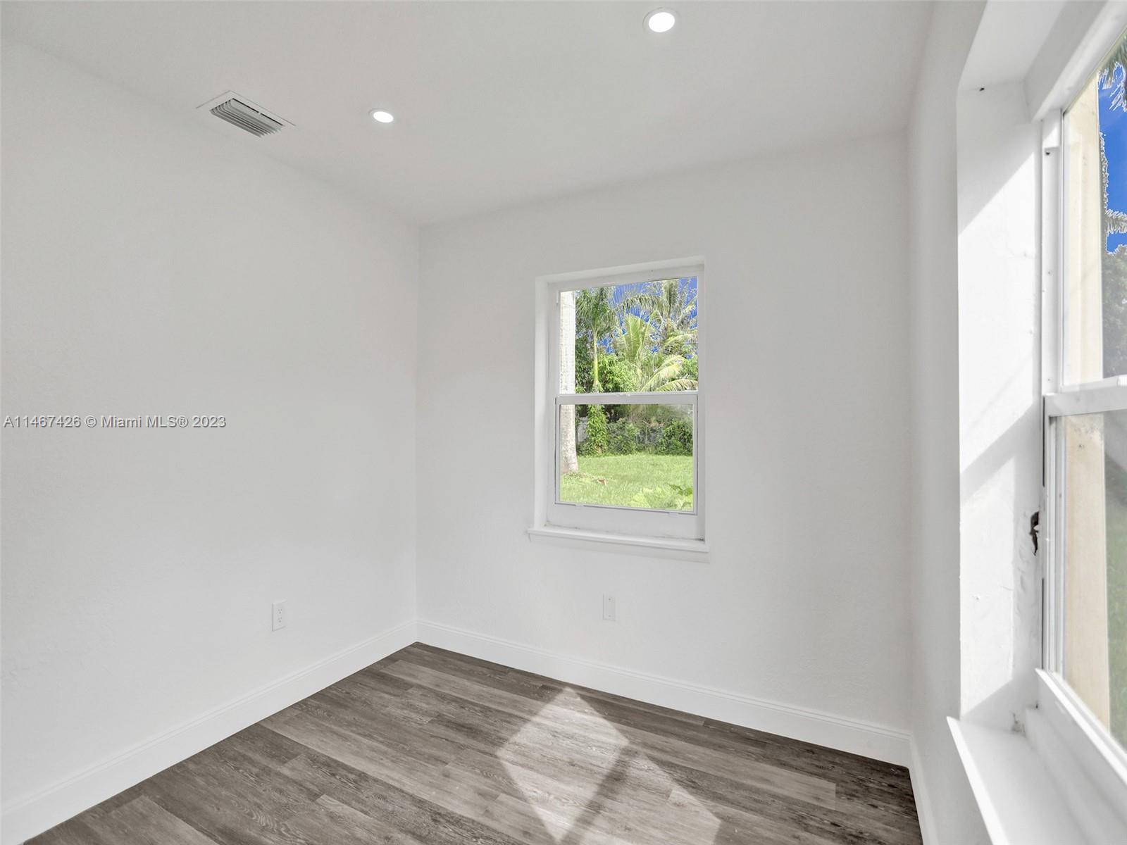 167 Northwest 84th Street Miami, FL 33150 - Photo 28 of 39 an empty room with windows and closet