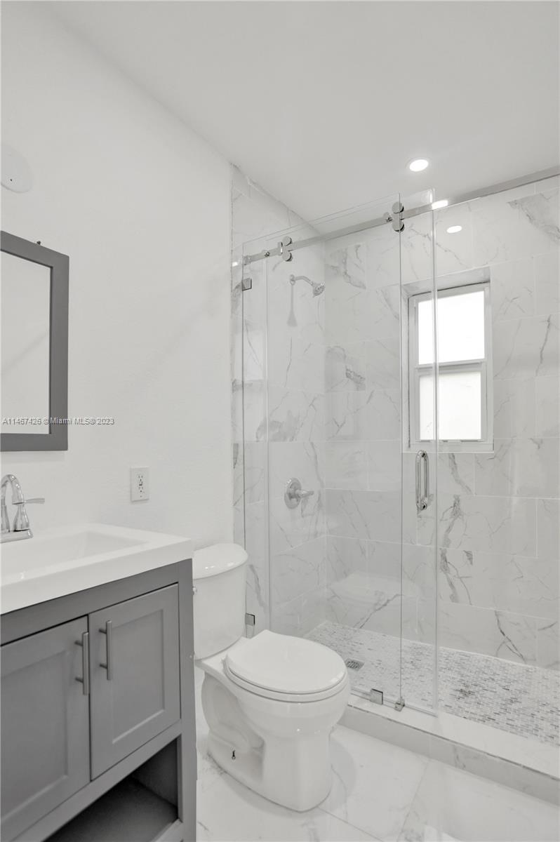 167 Northwest 84th Street Miami, FL 33150 - Photo 31 of 39 a bathroom with a sink a toilet and shower