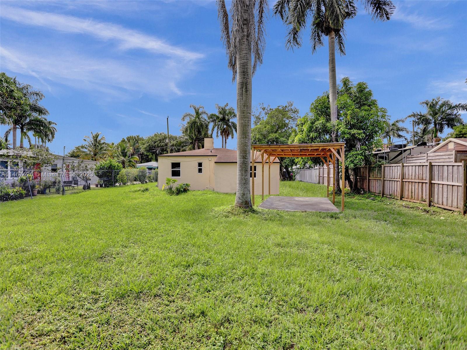 167 Northwest 84th Street Miami, FL 33150 - Photo 32 of 39 a view of a house with backyard and a garden