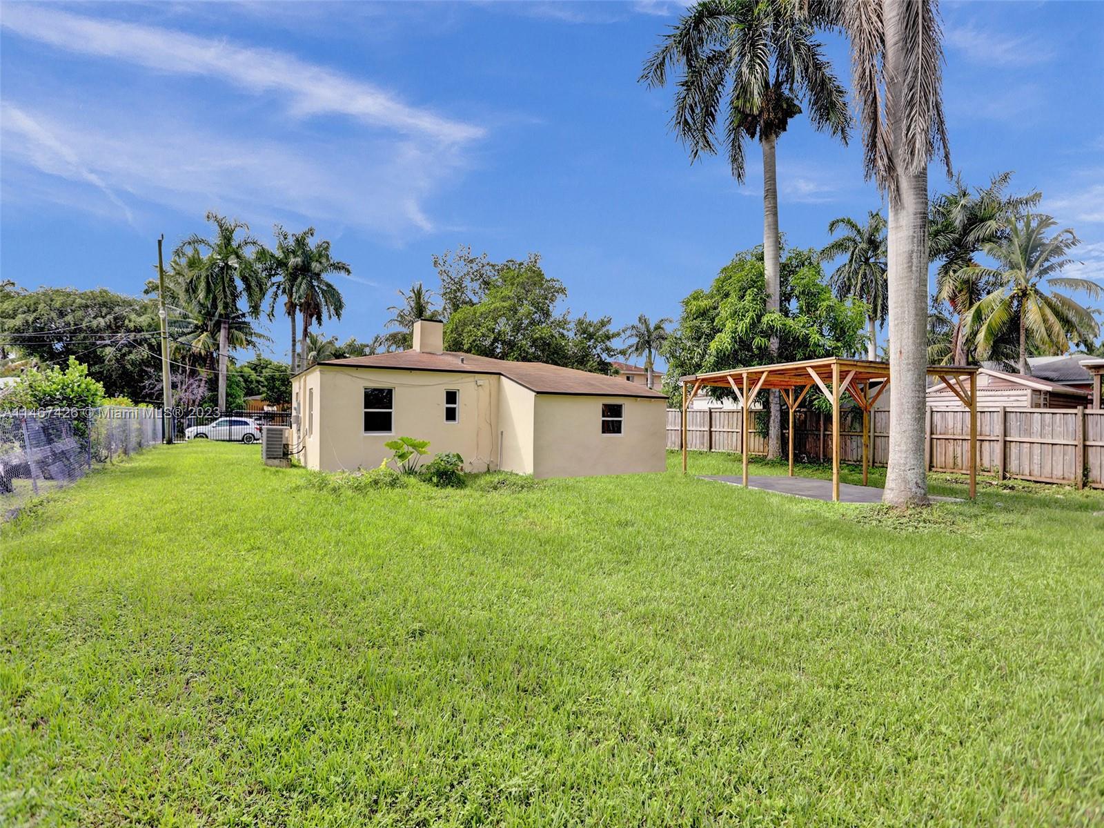 167 Northwest 84th Street Miami, FL 33150 - Photo 37 of 39 a view of a house with backyard and a tree