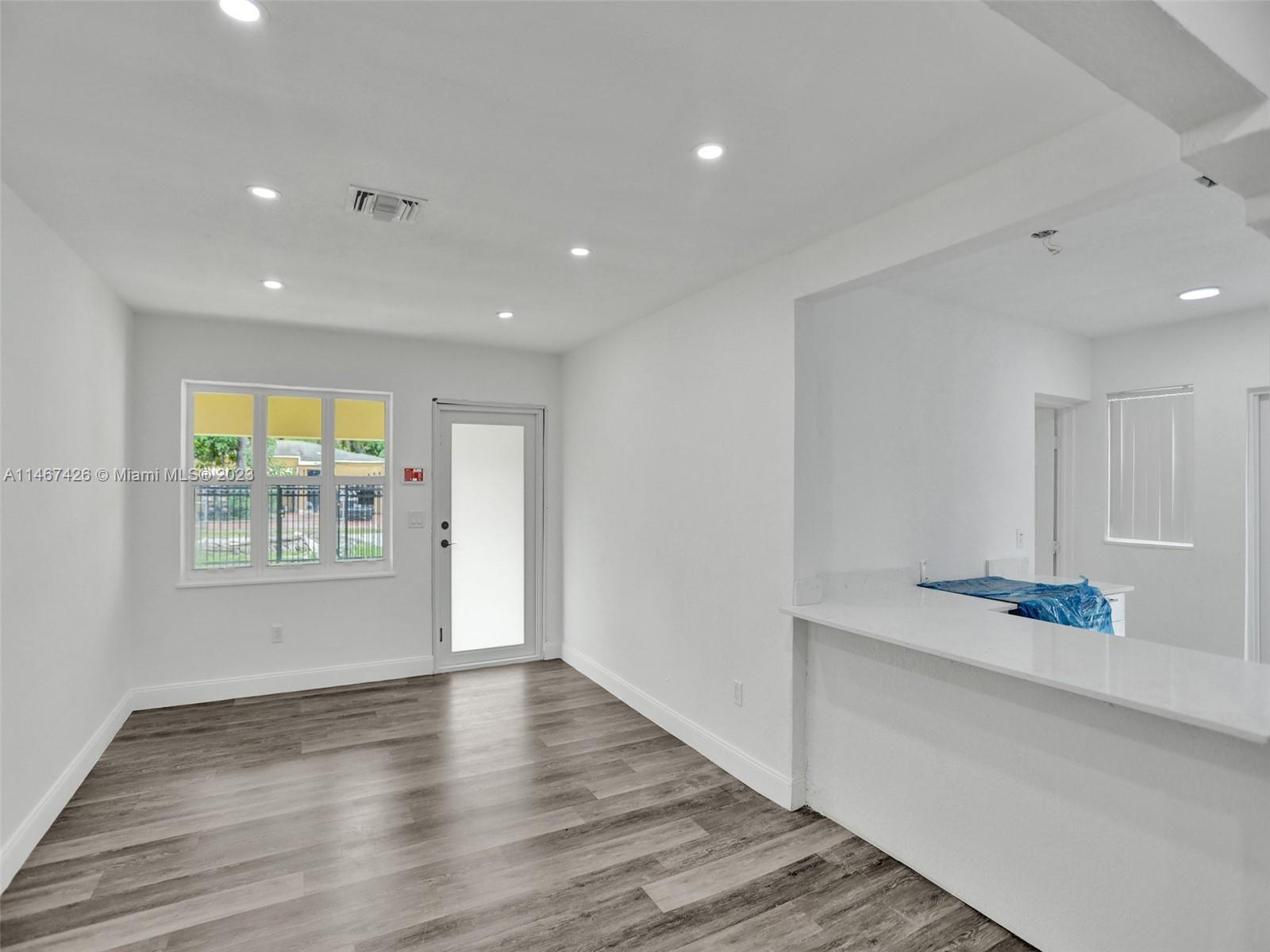 167 Northwest 84th Street Miami, FL 33150 - Photo 4 of 39 a view of an empty room with wooden floor and a window