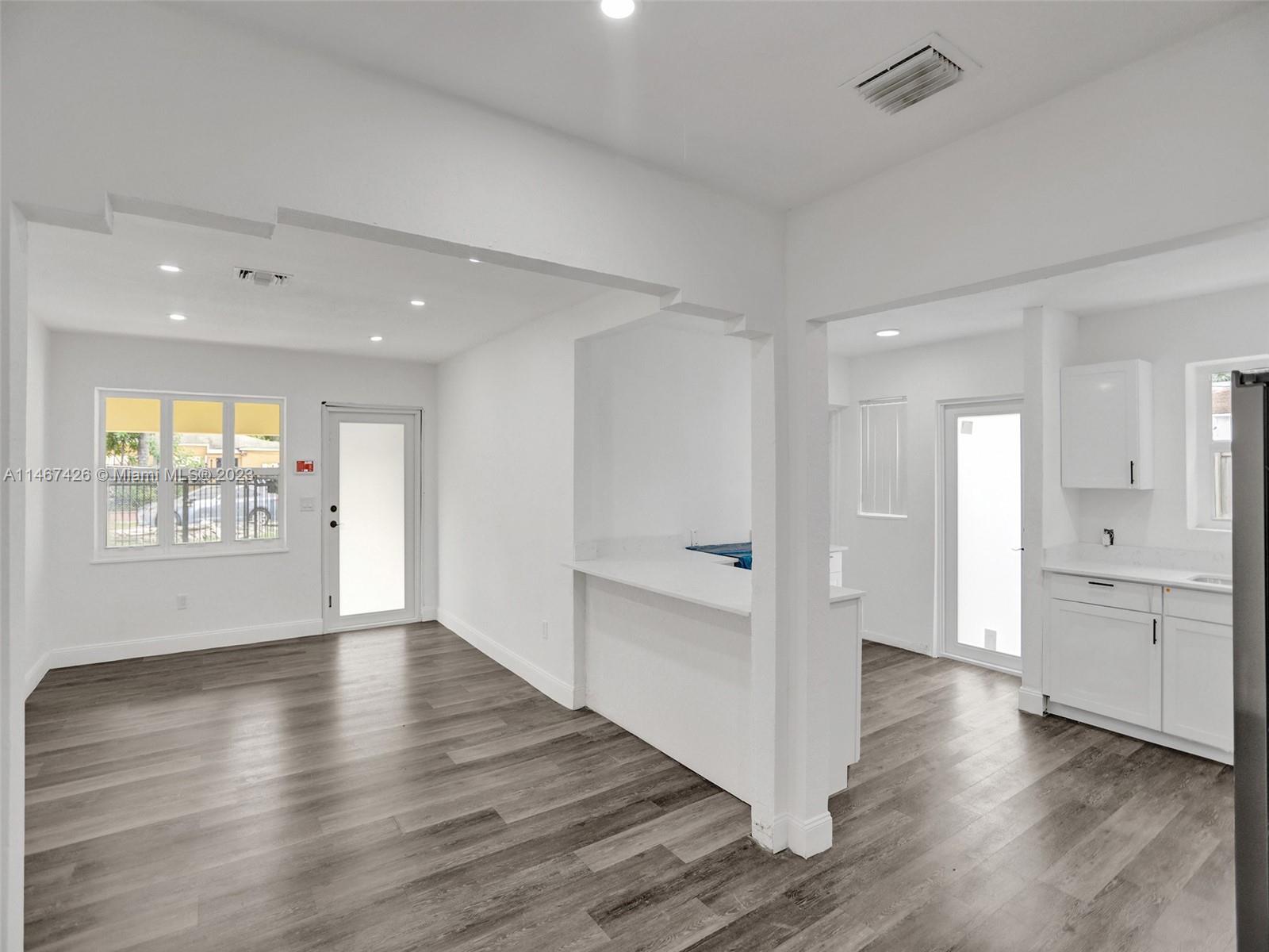 167 Northwest 84th Street Miami, FL 33150 - Photo 5 of 39 a view of an empty room and window and wooden floor