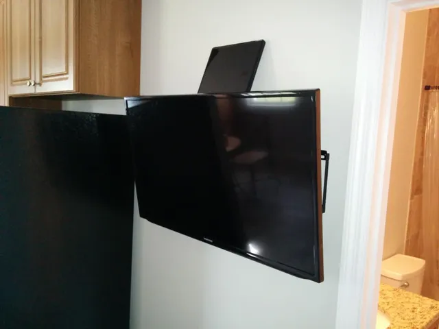a metallic refrigerator freezer sitting in a kitchen