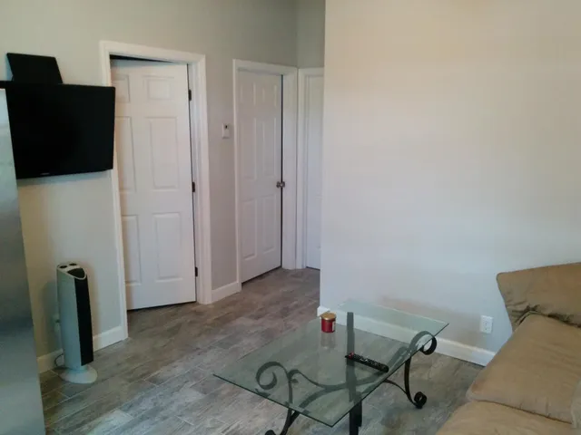 a kitchen with stainless steel appliances granite countertop a table chairs and a refrigerator