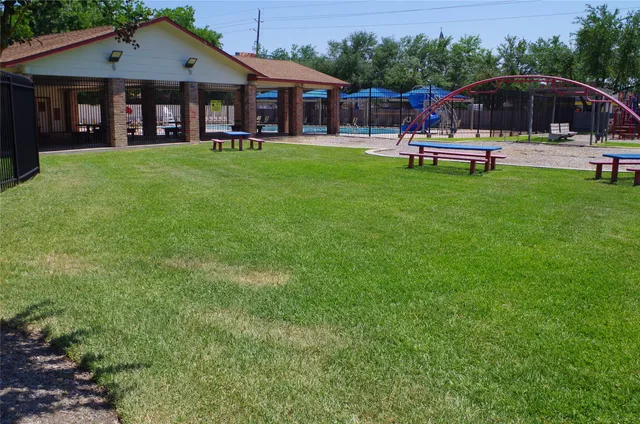 a front view of a house with a garden and trees