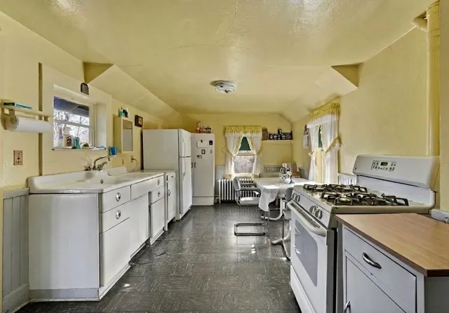 a kitchen with stainless steel appliances a stove a sink dishwasher and a refrigerator